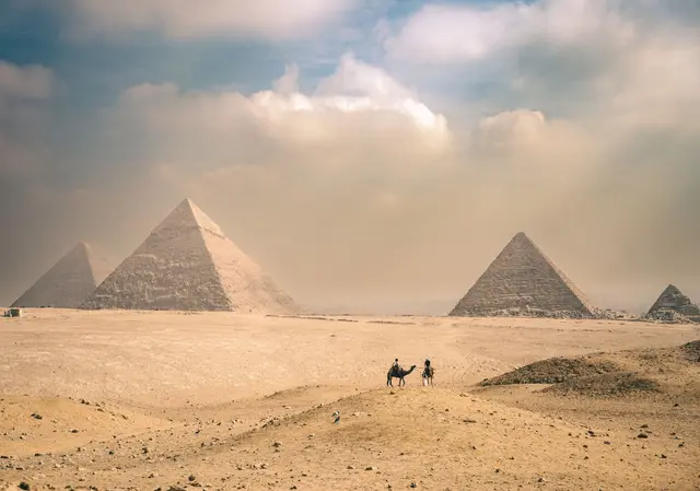 The Pyramids of Giza with camels in the desert, Egypt